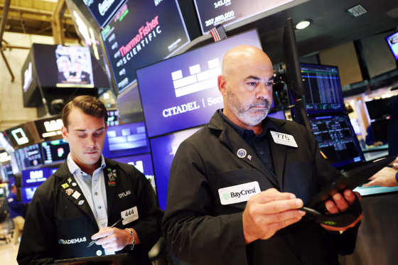 Traders work on the floor of the NYSE