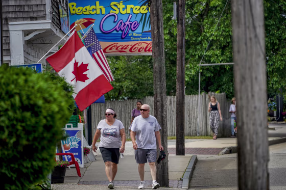 A Canadian flag flies outside a shop