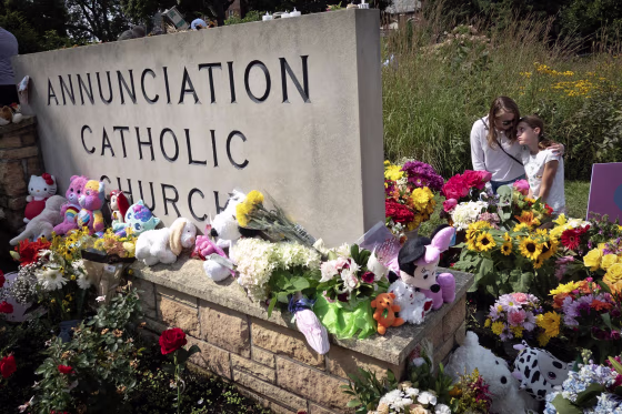 People visit a memorial outside of Annunciation Catholic Church on Aug. 29, 2025 in Minneapolis.