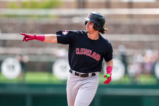 Chase DeLauter points while running on the baseball field