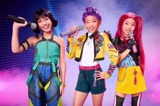 Three girls dressed up in Halloween costumes depicting characters from the girl group in KPop Demon Hunters