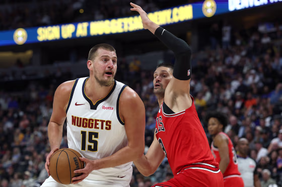 Nikola Jokic of the Denver Nuggets drives against Nikola Vucevic of the Chicago Bulls on Oct. 14, 2025.