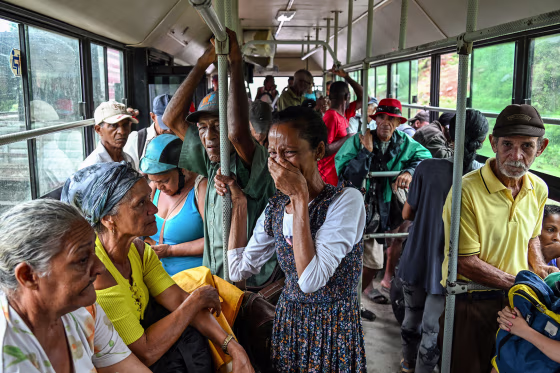 A woman reacts on the bus as residents are evacuated to safe locations ahead of the arrival of Hurricane Melissa.
