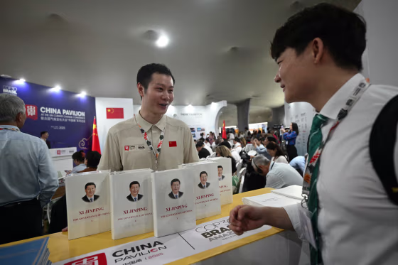 A visitor looks at Xi Jinping's book at China's Pavillion during the COP30 UN Climate Change Conference in Belem, Brazil on Nov. 10.