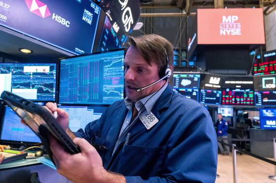 Traders work on the floor of the New York Stock Exchange on November 18, 2025.