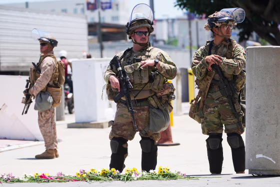 Members of the California National Guard and U.S. Marines guard a federal building