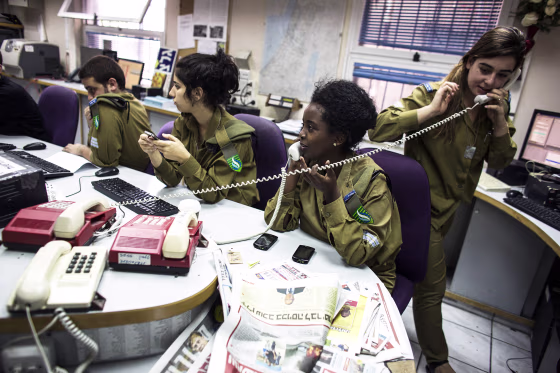 Israeli soldiers from Galei Tzahal, the Israeli army radio station, work in the newsroom at the station's studios in Jaffa