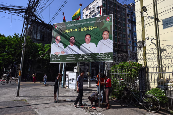 Members of Union Solidarity and Development Party remove their signboard on the final day of the campaign ahead of the start of Myanmar's general election in Yangon.