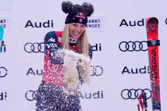 Lindsey Vonn sprays sparkling wine as she celebrates on the podium after winning an alpine ski women's World Cup downhill in Zauchensee, Austria, Saturday, Jan. 10, 2026.