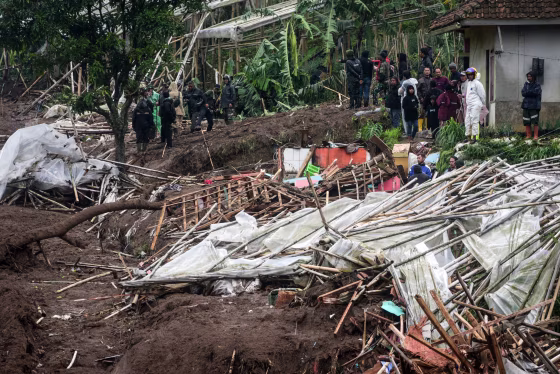 Rescuers search for victims buried by a landslide in Pasirlangu village, Bandung, West Java, on January .