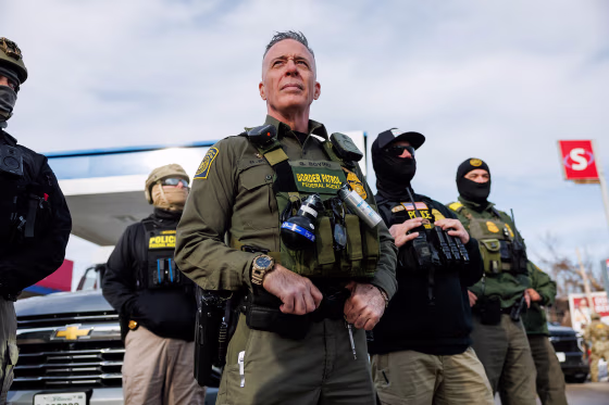 U.S. Border Patrol Commander Gregory Bovino and other agents at a gas station