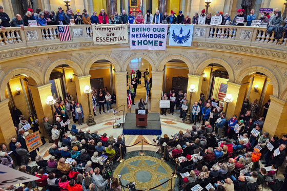 A large group of people gather in the rotunda of the Minnesota State Capitol in St. Paul/