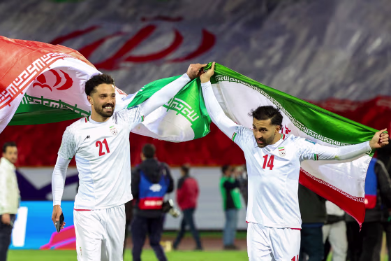 Iran's Omid Norafkan and Saman Ghoddos celebrate their victory in a World Cup qualifier against Uzbekistan on March 25, 2025 in Tehran.