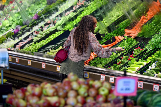 A customer shops produce.