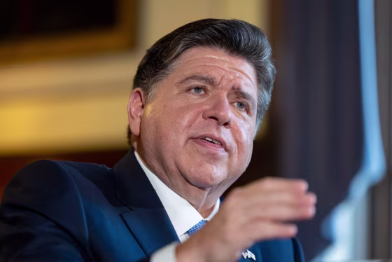 JB Pritzker speaks at a meeting.