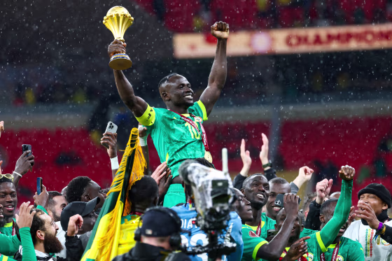 Senegal's forward Sadio Mane celebrates with the trophy after winning the Africa Cup of Nations (CAN) final football match against Morocco on Jan. 18, 2026. 