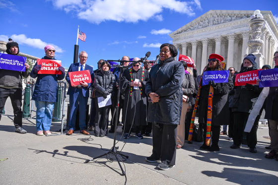 Image: Guerline Jozef, co-founder and Executive Director of Haitian Bridge Alliance, speaks in front of the US Supreme Court in Washington, D.C.