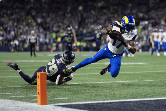 Davante Adams of the Los Angeles Rams dives with a ball against Josh Jobe of the Seattle Seahawks