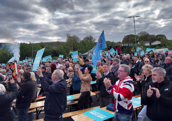 Crowds cheer Reform party leader Nigel Farage as he takes the stage at a rally in Merthyr Tidfil, Wales on Tuesday.