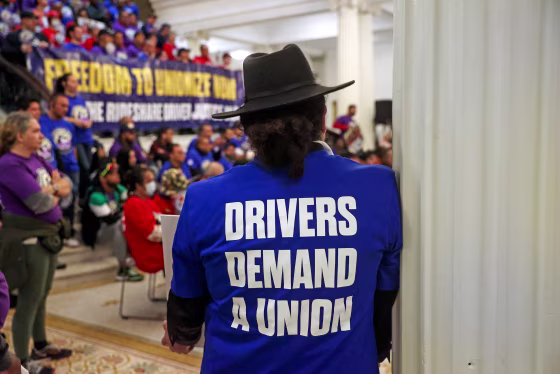 Uber and Lyft drivers at a rally inside the Massachusetts State House.