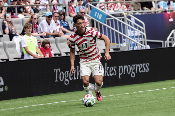 Sebastian Berhalter dribbling a soccer ball during a game.