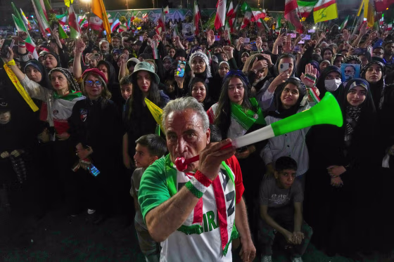 A man blows a plastic trumpet during a rally in support of Iran's World Cup team in Tehran on May 13, 2026.