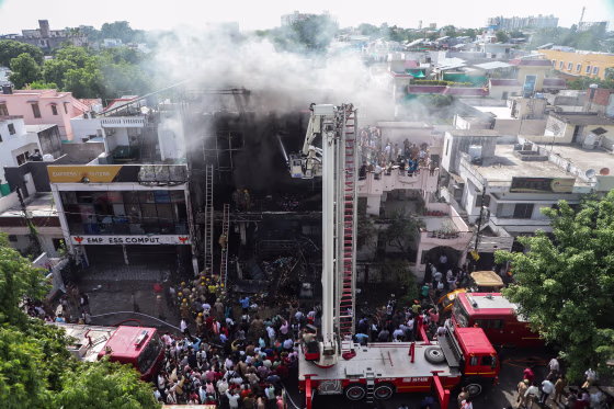 Firefighters try to douse a fire that broke out at a coaching institute.