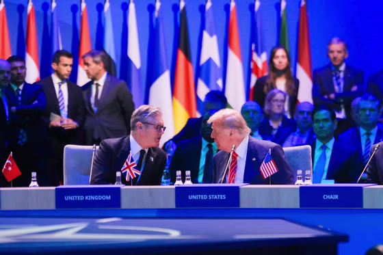 President Donald Trump speaks to Britain's Prime Minister Keir Starmer at the NATO summit.