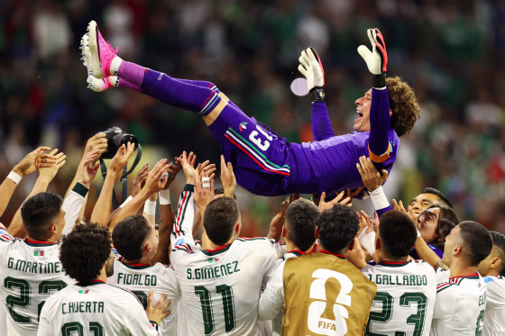 Guillermo Ochoa #13 of Mexico is tossed into the air by his teammates after the team's 3-0 victory.