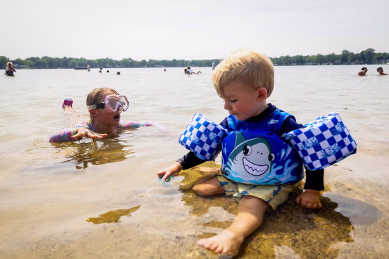 Atticus Dryden plays in the water with his sister, Penelope Dryden,