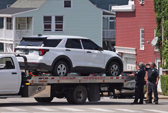 Authorities tow a car from the scene of an ICE shooting on July 13, 2026, in Biddeford, Maine.