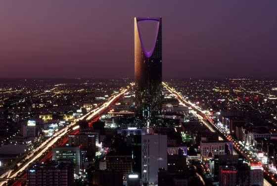 The Burj al-Mamlaka rises above the skyline of Riyadh at dusk.