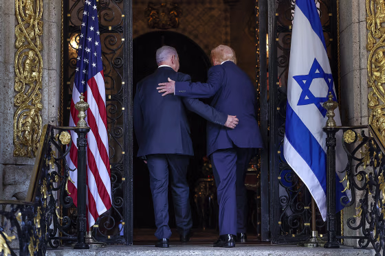 President Trump and Benjamin Netanyahu walk away from the camera through a gilded doorway.