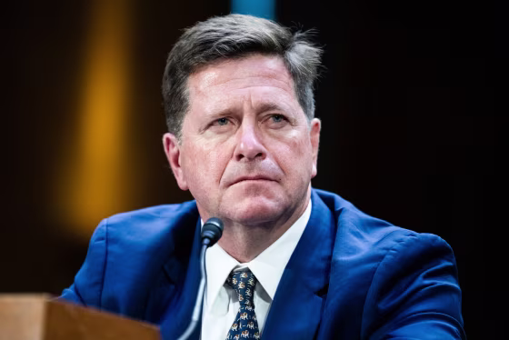 Jay Clayton sits in a hearing room