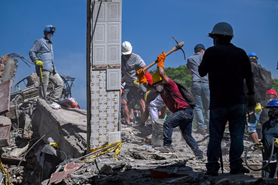 Rescuers help remove debris.