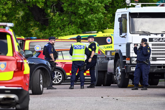 Police officers and rescue services work at the scene.