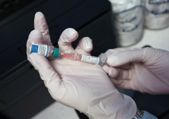 A Medical Assistant draws a measles, mumps and rubella, vaccination.
