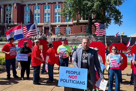 People protest in front of the state Supreme Court. 