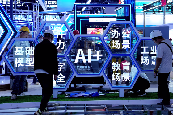 Image: A blue sign featuring the word "AI" in the center. Men wearing construction helmets are surrounding the sign;