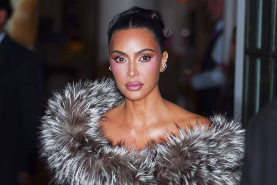 Image: Kim Kardashian with her hair tied back, wearing a fur shawl