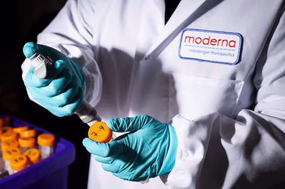 A researcher works in the lab at the Moderna headquarters in Cambridge, Mass.
