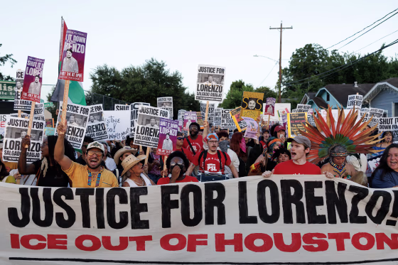 A crowd of protestors standing behind a banner reading JUSTICE FOR LORENZO! ICE OUT OF HOUSTON