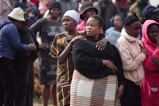 People gather near the crime scene where the body of a woman was discovered in Boksburg on September 17, 2026.