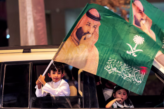 A child waves a flag of Saudi Crown Prince Mohamed Bin Salman