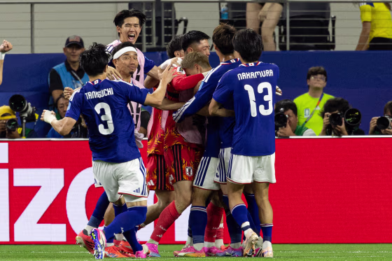 Players of Japan celebrate after scoring a goal during FIFA