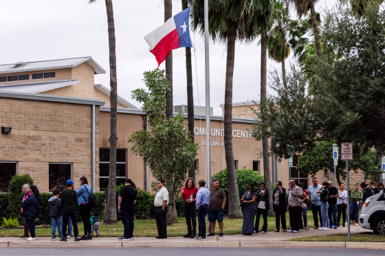 Voters wait outside of a polling place.