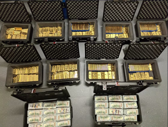 Black briefcases filled with gold bars and stacks of 100 dollar bills