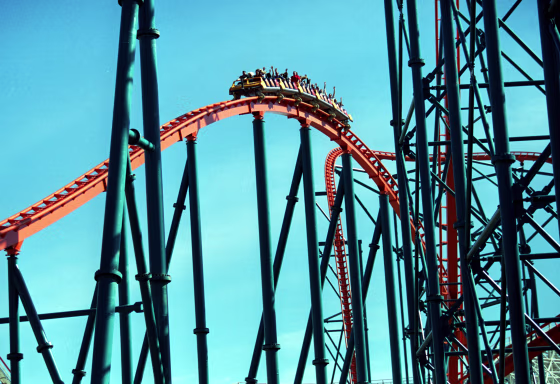 Roller coaster riders throw their hands in the air as they ride "Goliath,".