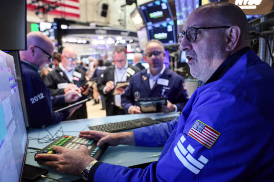 Traders work on the floor.