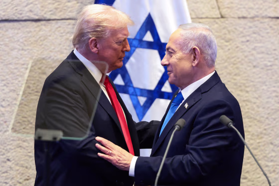Image: President Donald Trump and Israeli Prime Minister Benjamin Netanyahu greet each other in front of an Israeli flag